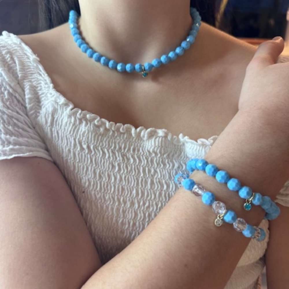 Baby blue beaded necklace with two matching bracelets.